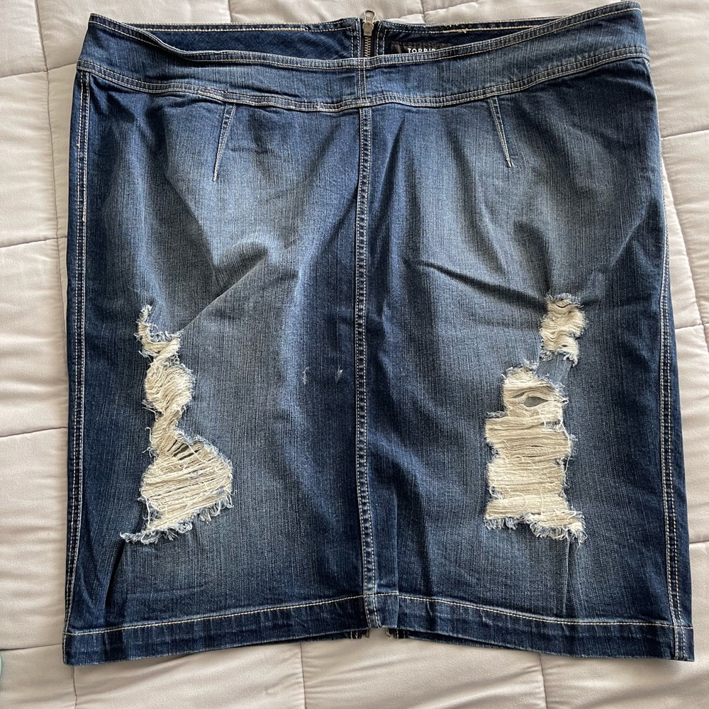 Destructed denim skirt with rear zipper.
